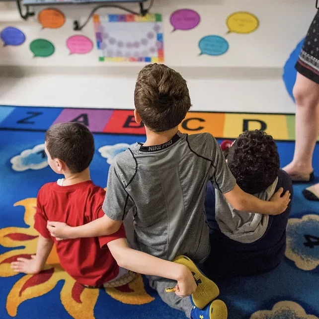 children sitting on a play mat