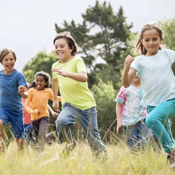 A group of kids running in the forest