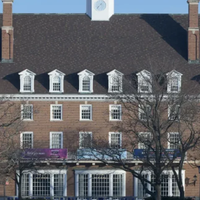 The exterior of a brick building with trees in front