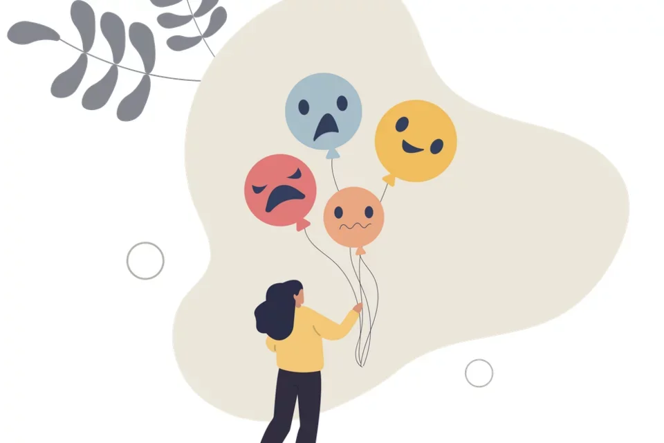 A woman holding baloons representing her emotions