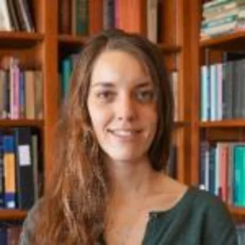a white woman against a bookshelf