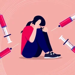 image of woman holding her heard in distress with vaccines around her