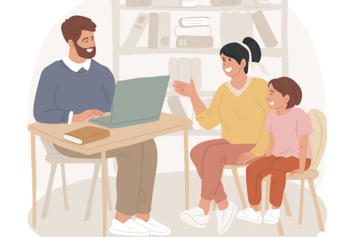 A parent and child speaking with a teacher