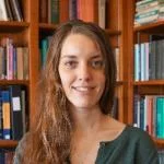 Image of a white woman against a bookshelf